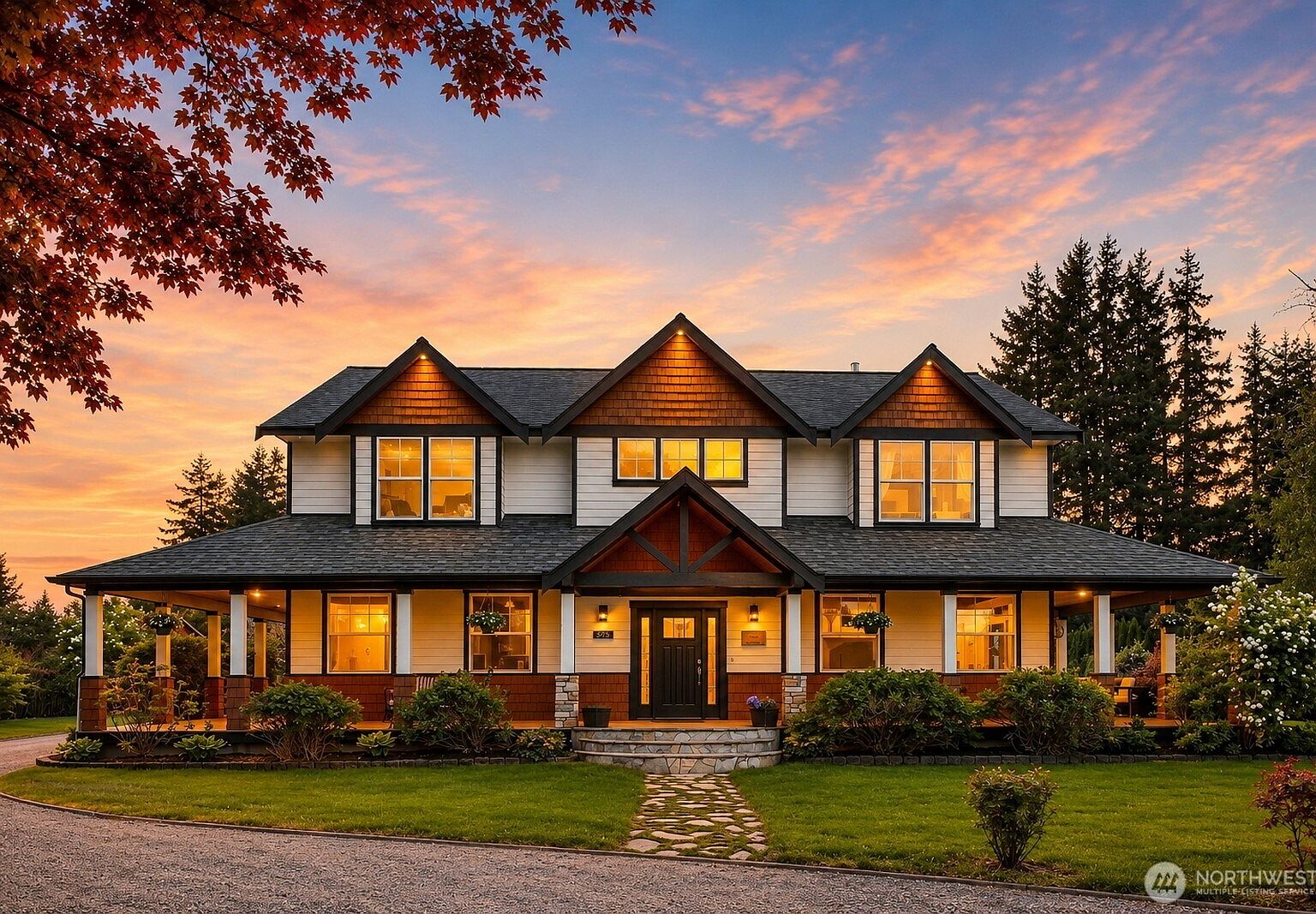 A craftsman estate at dusk with illuminated windows, set on one acre at the edge of the Pacific Northwest cedar forest.